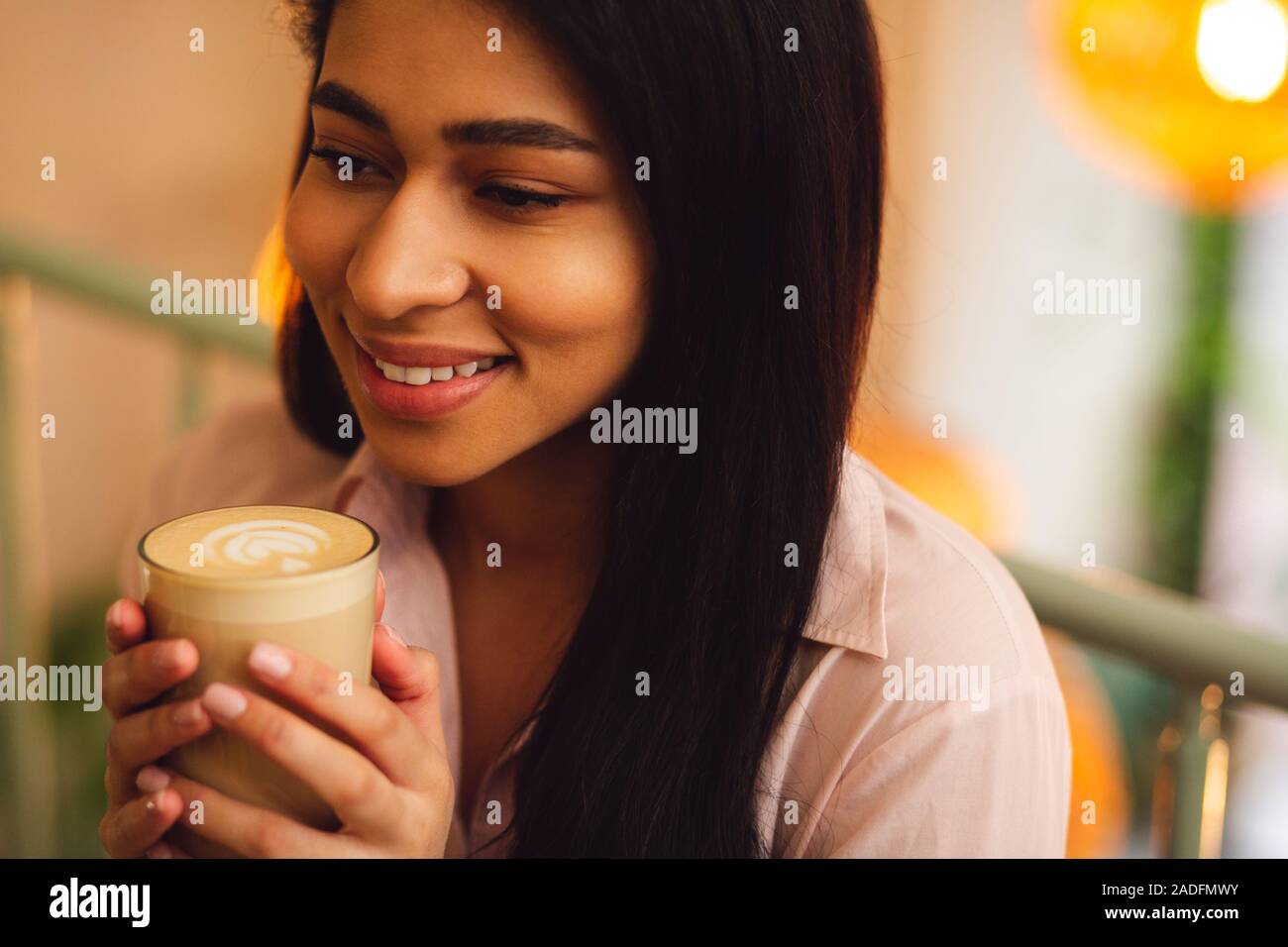 Close up of coffee drink in hands of smiling lady Stock Photo