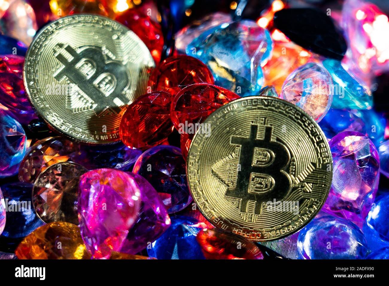 Golden Bitcoin cryptocurrency mining concept. Bitcoin Gold coins studded  with colored gemstones Stock Photo - Alamy
