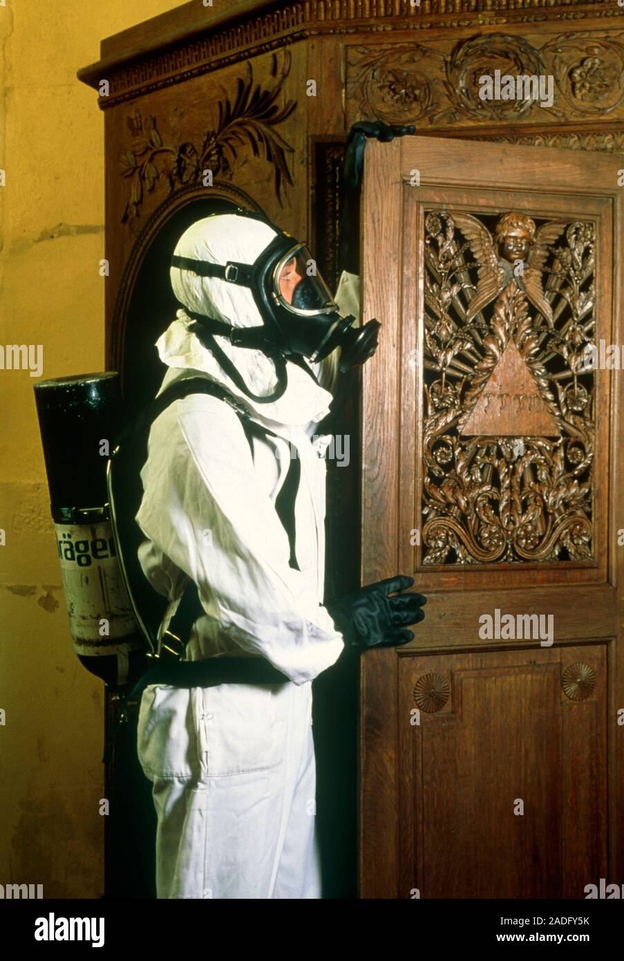 Termite fumigation. Female technician wearing protective clothing and a