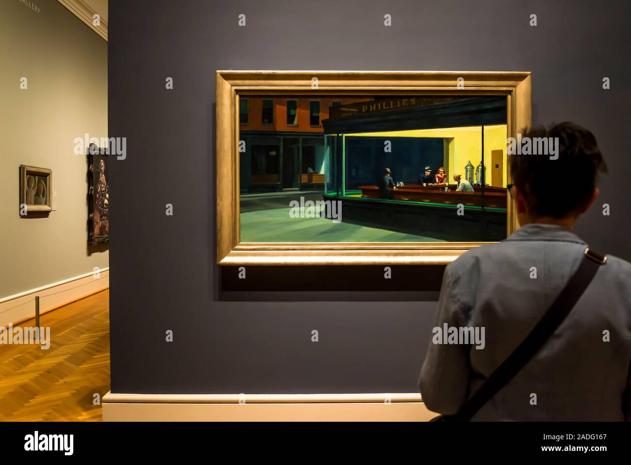 Visitor looking at Edward Hopper painting Nighthawks, The Art Institute of Chicago, Chicago, Illinois, USA Stock Photo