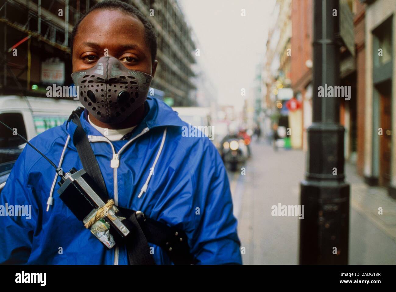 A cyclist wearing a fume mask on his face. The mask provides some