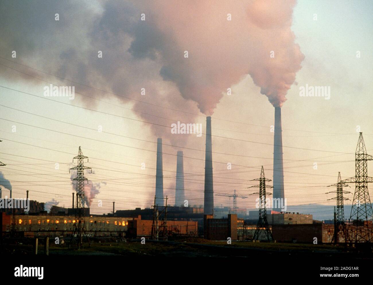 Air pollution. Chimneys of a nickelsmelting factory release fumes into