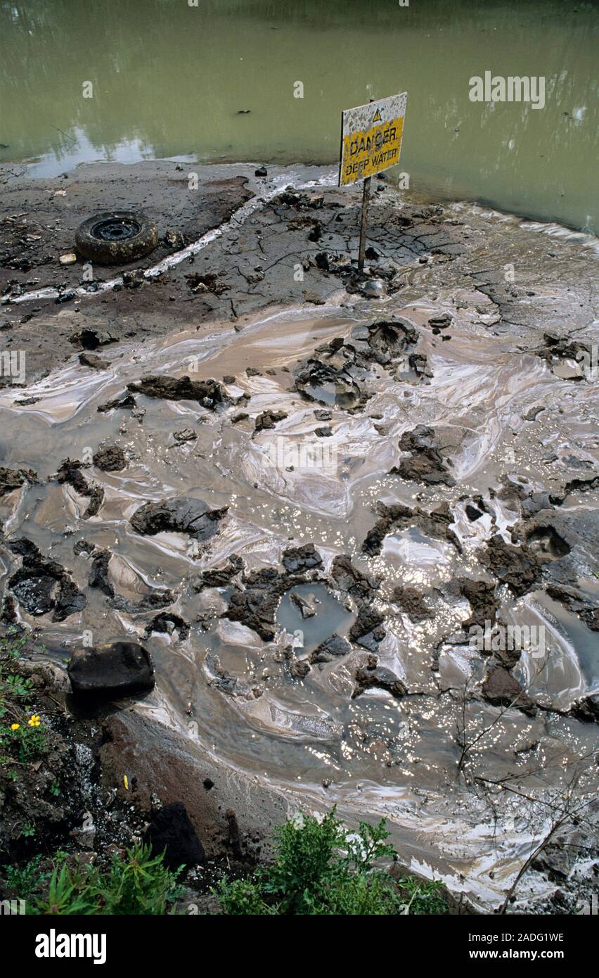 Water pollution. Polluted water near a waste dump used by an iron