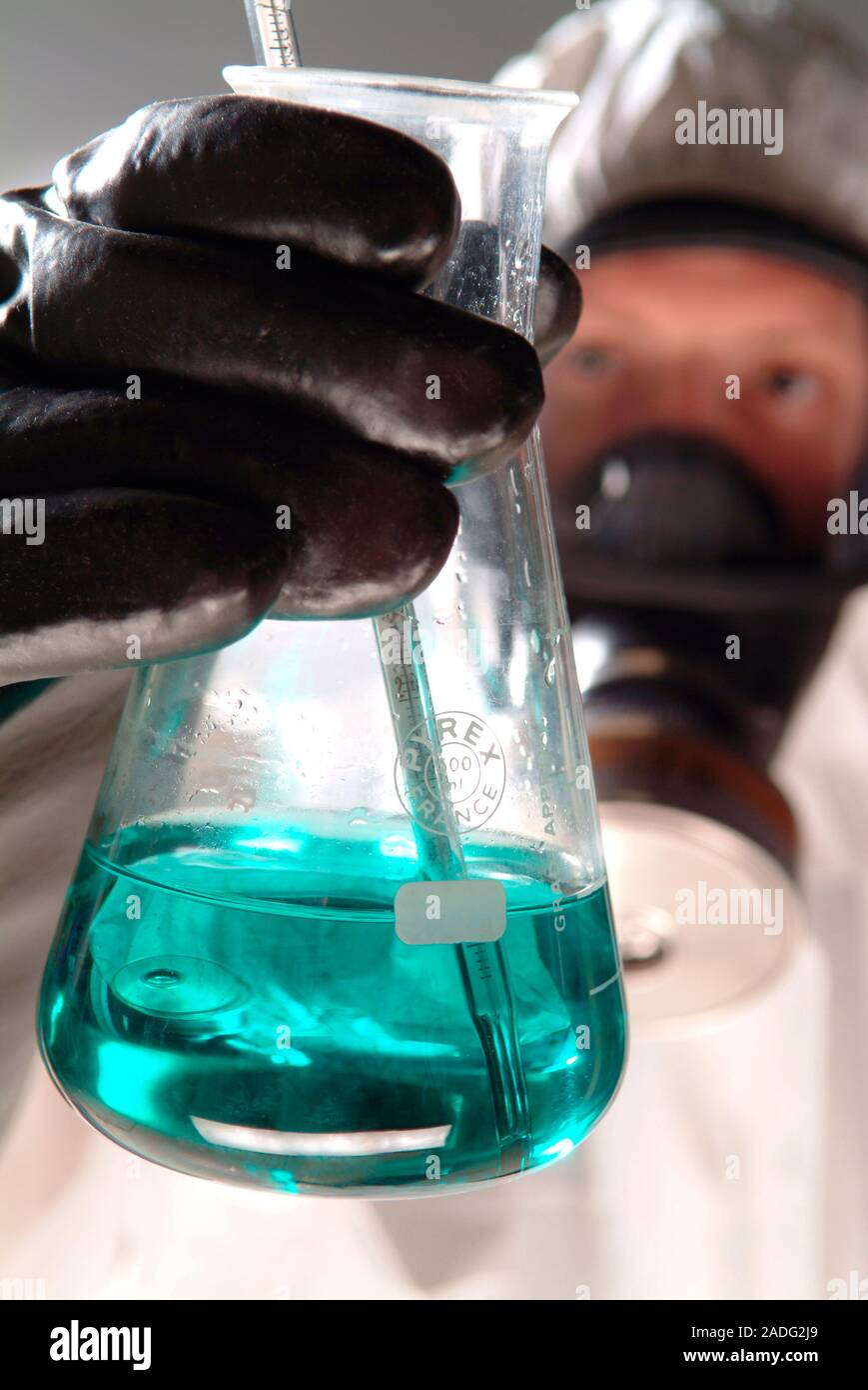 Handling toxic material. Man wearing a protective suit, breathing