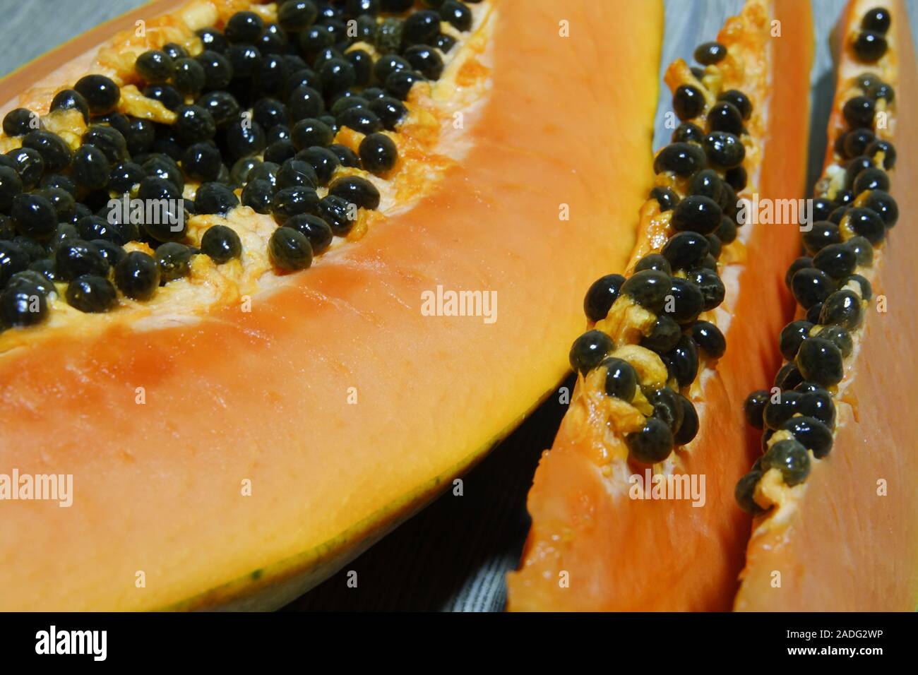 Fresh sliced papaya with seeds inside closeup. Half of yellow papaya Stock Photo Alamy