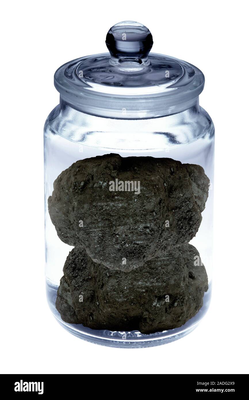 Carbon capture, conceptual image. Lumps of coal inside a jar