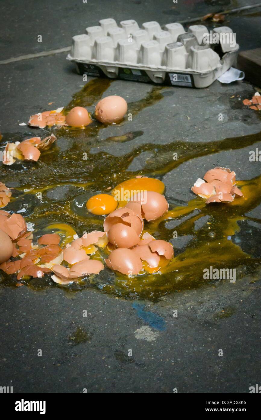 A Dozen Broken Eggs on a Sidewalk, USA Stock Photo