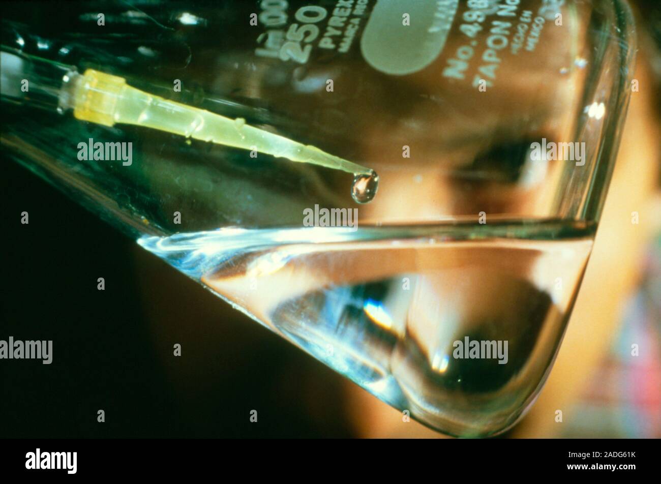 Closeup of scientist pipetting a droplet of solution containing DNA