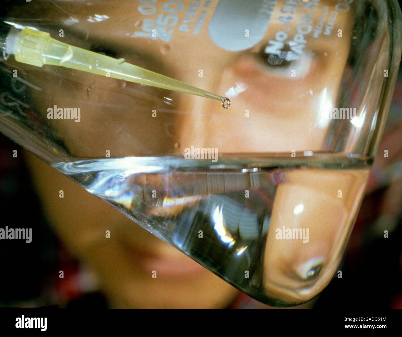 Closeup of scientist pipetting a droplet of solution containing DNA