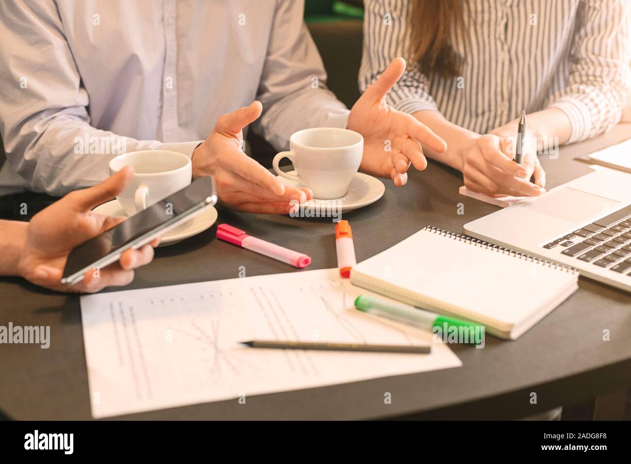 Partners discussing new business strategy with graphs Stock Photo