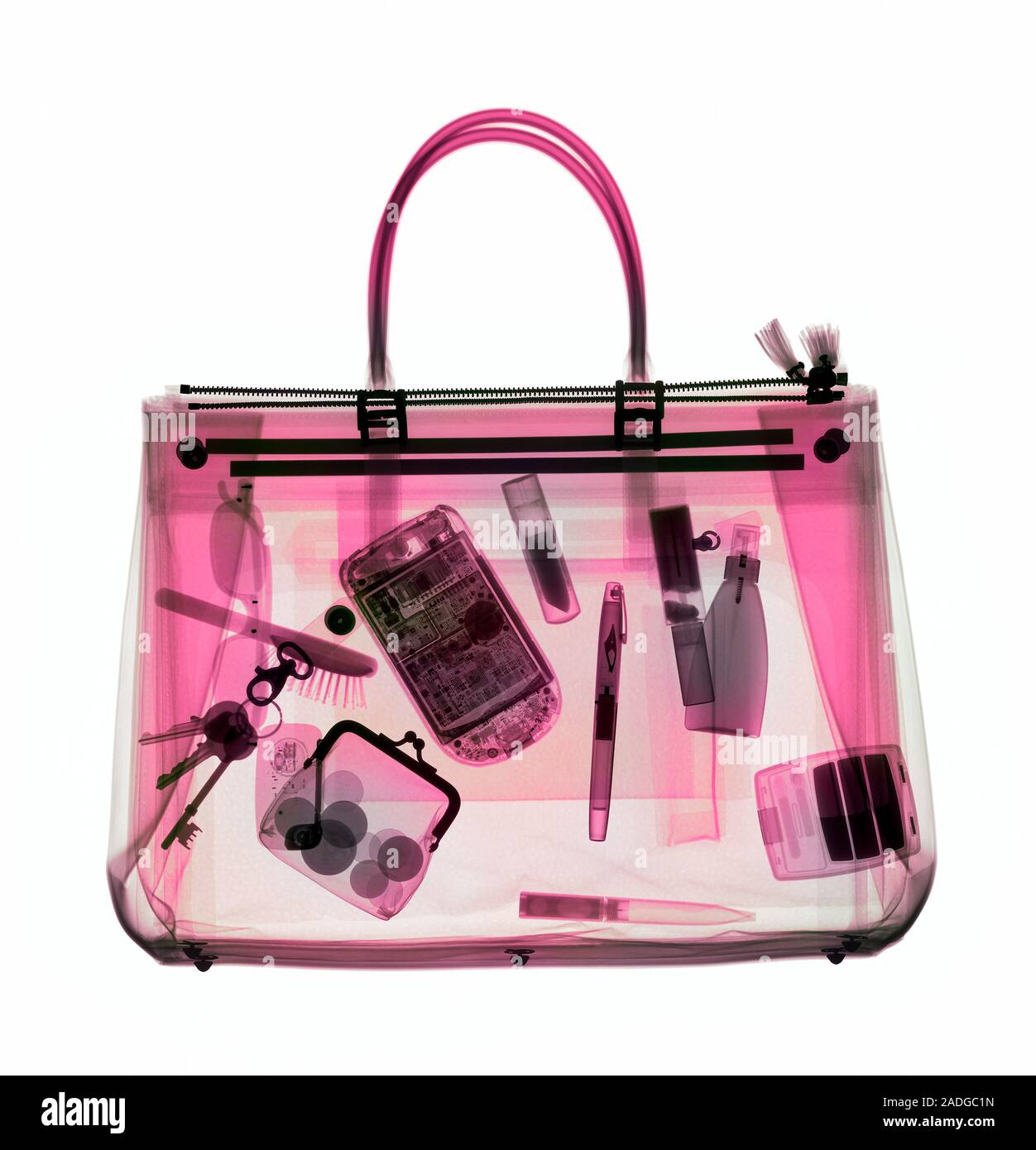 Handbag, coloured X-ray. Its contents include make-up, a purse, keys, pens and a mobile phone. Stock Photo