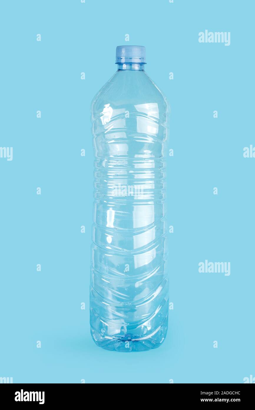 Empty plastic water bottle on a blue background Stock Photo