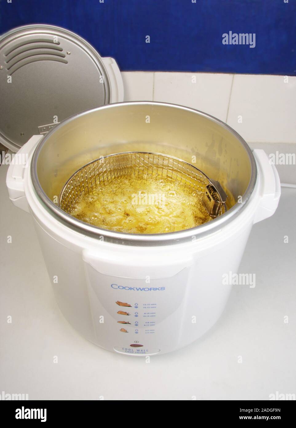 Chips in deep fat fryer. Deep fat fryer being used to cook potato chips