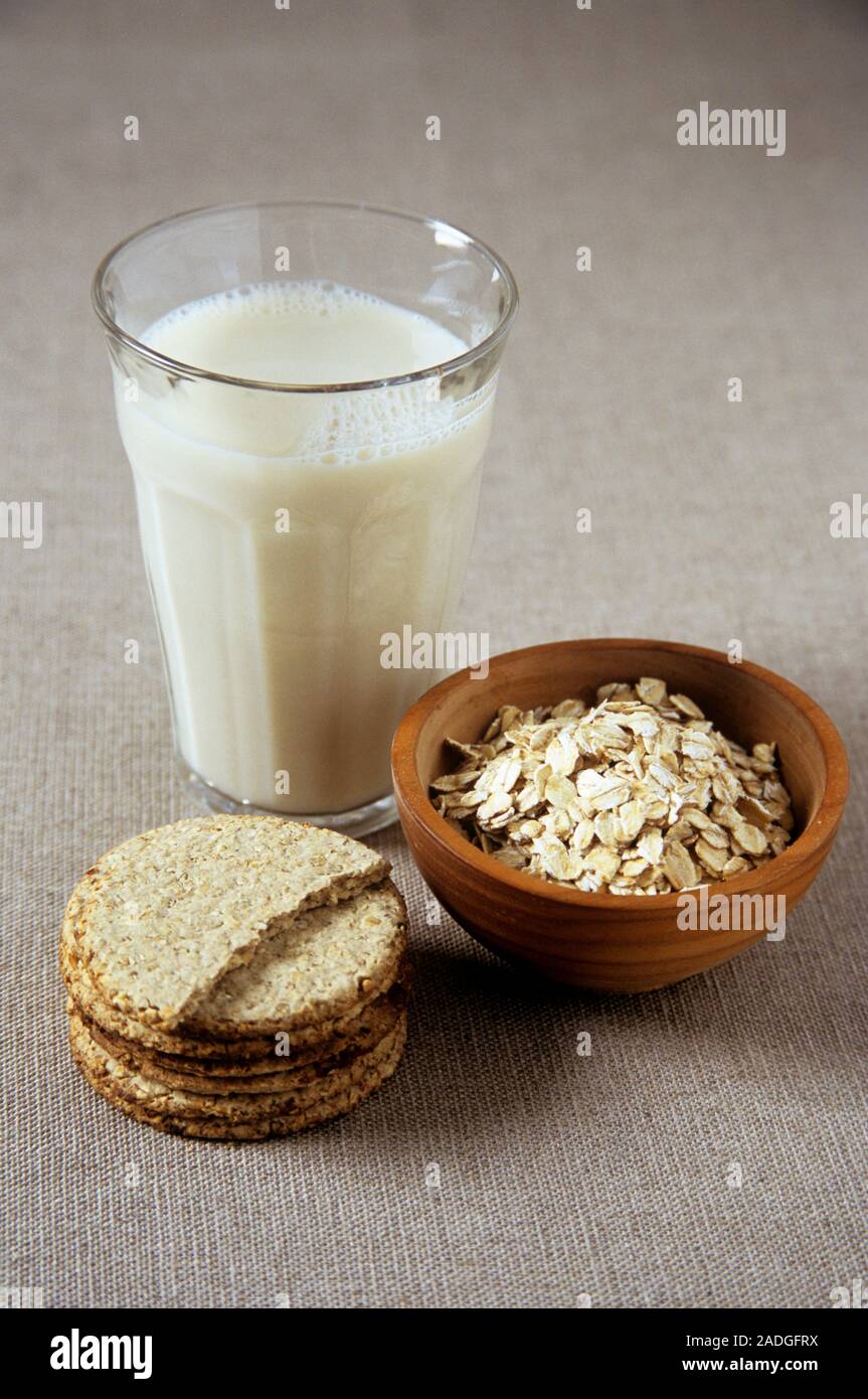 Oat products. Selection of food products derived from oats. These are oat milk (top), oat flakes (right) and oatcakes (left). Oats are contain a good Stock Photo