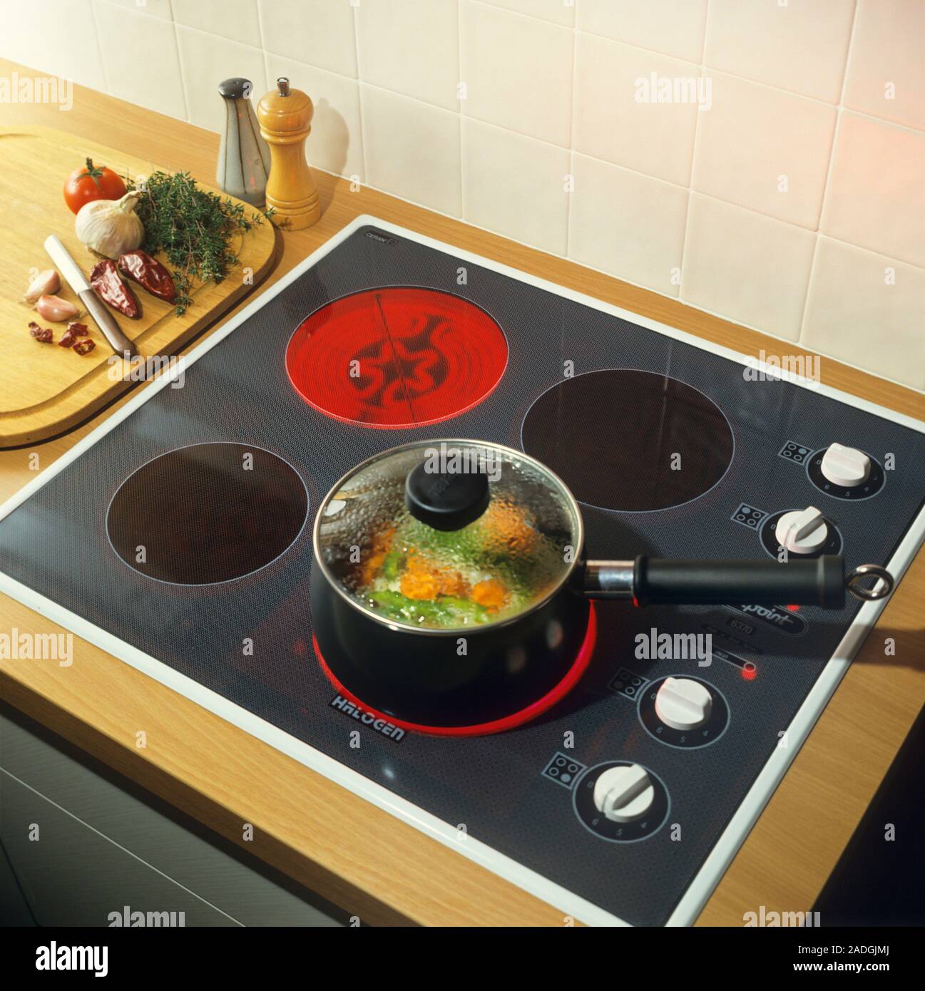 Ceramic hob. Saucepan of vegetables being heated on a ceramic hob. This