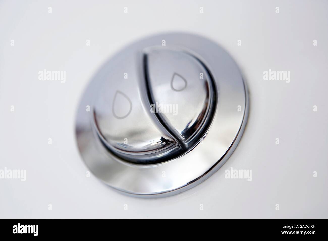 Dual flush button on a toilet. Toilets with dual flush buttons have a