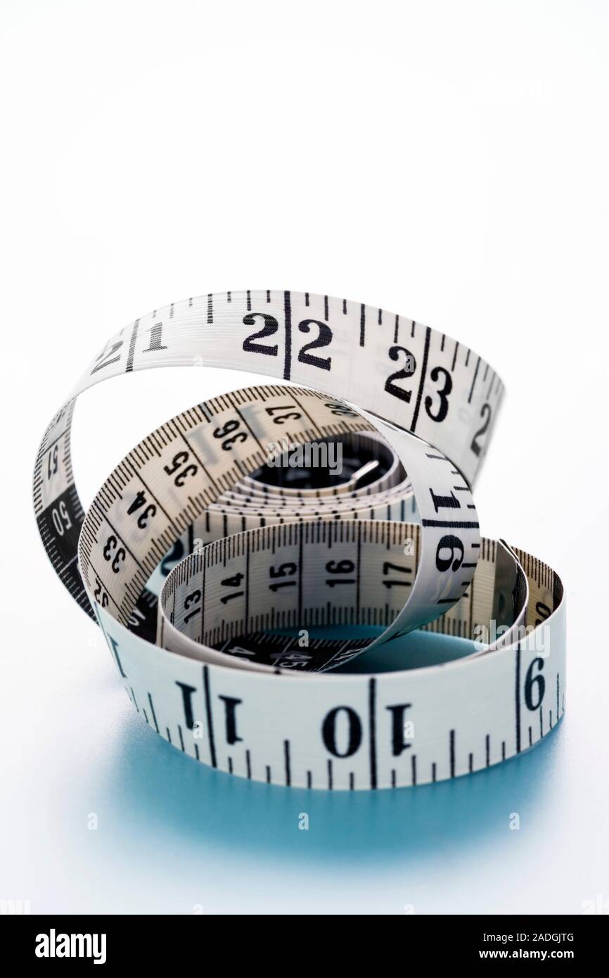 Tape measure marked with centimetres and inches Stock Photo Alamy
