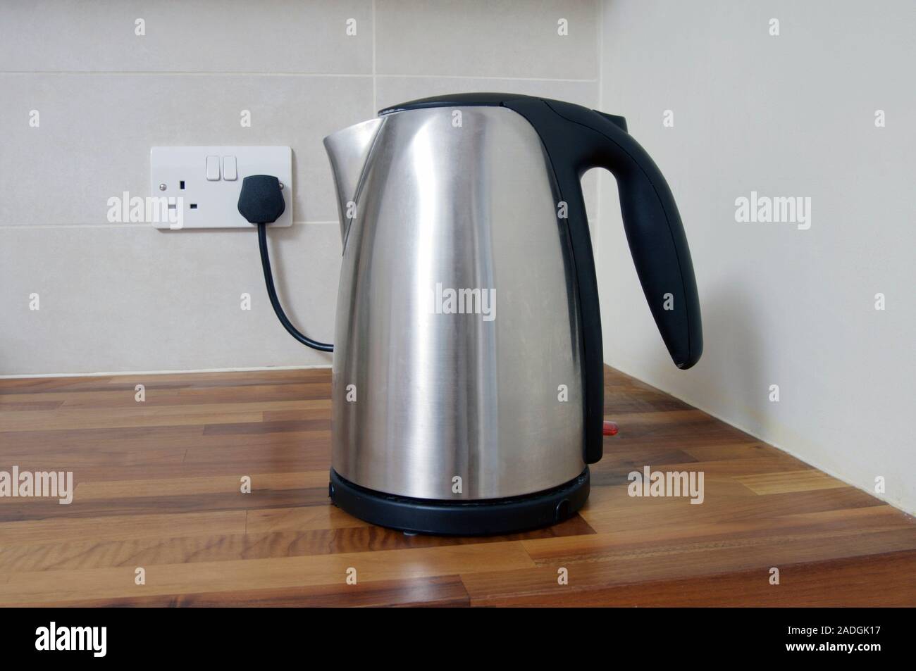 Electric kettle plugged into a wall socket Stock Photo Alamy