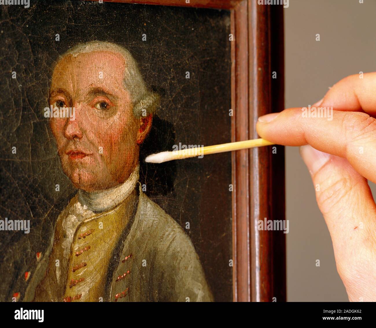 Art restoration. Technician touching up an oil painting with