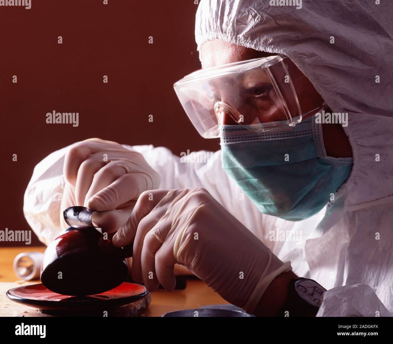 Lifting fingerprints. Image 3 of 3. Forensic officer using an adhesive