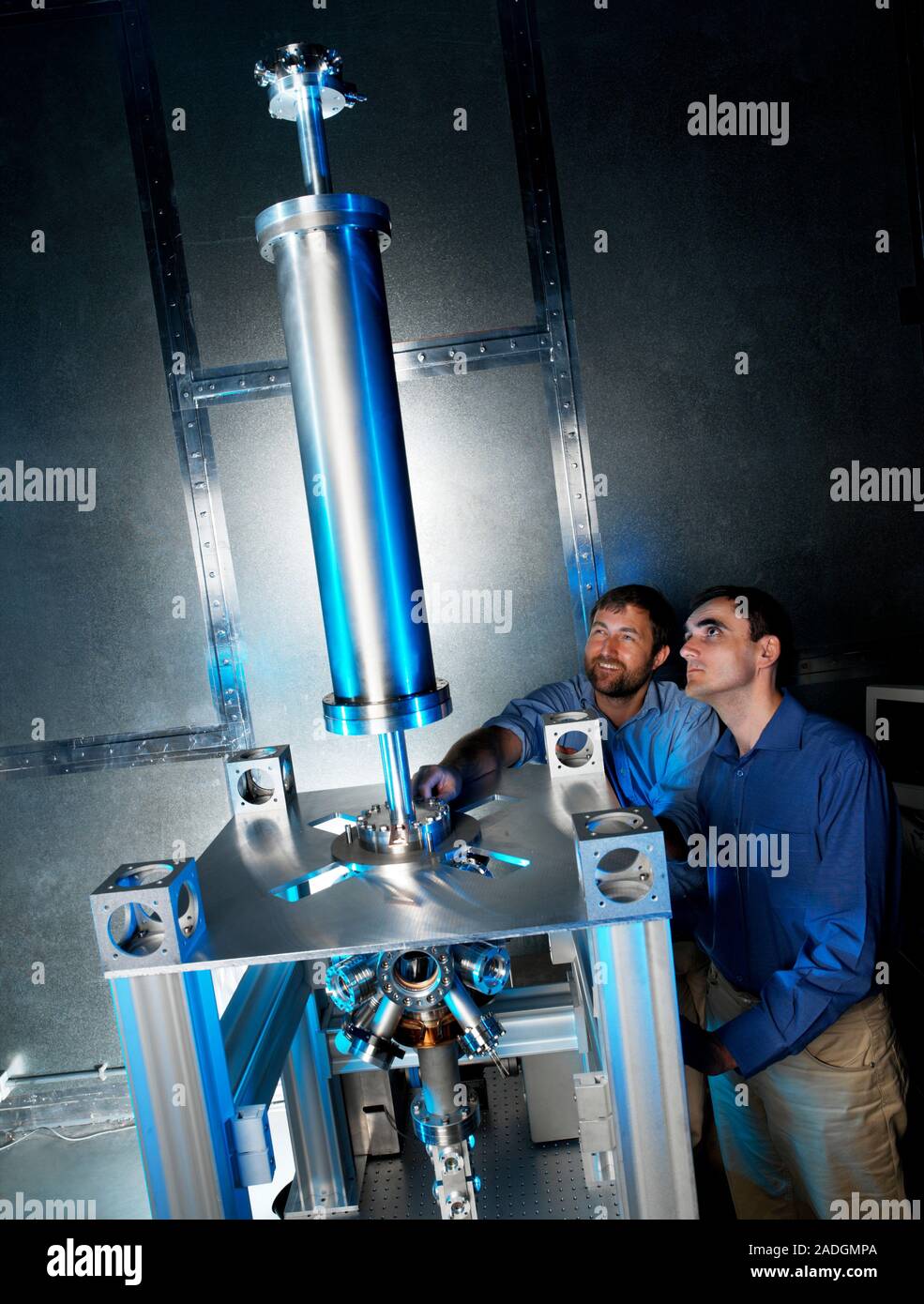 Caesium clock vacuum chamber. Physicists adjusting the settings to a