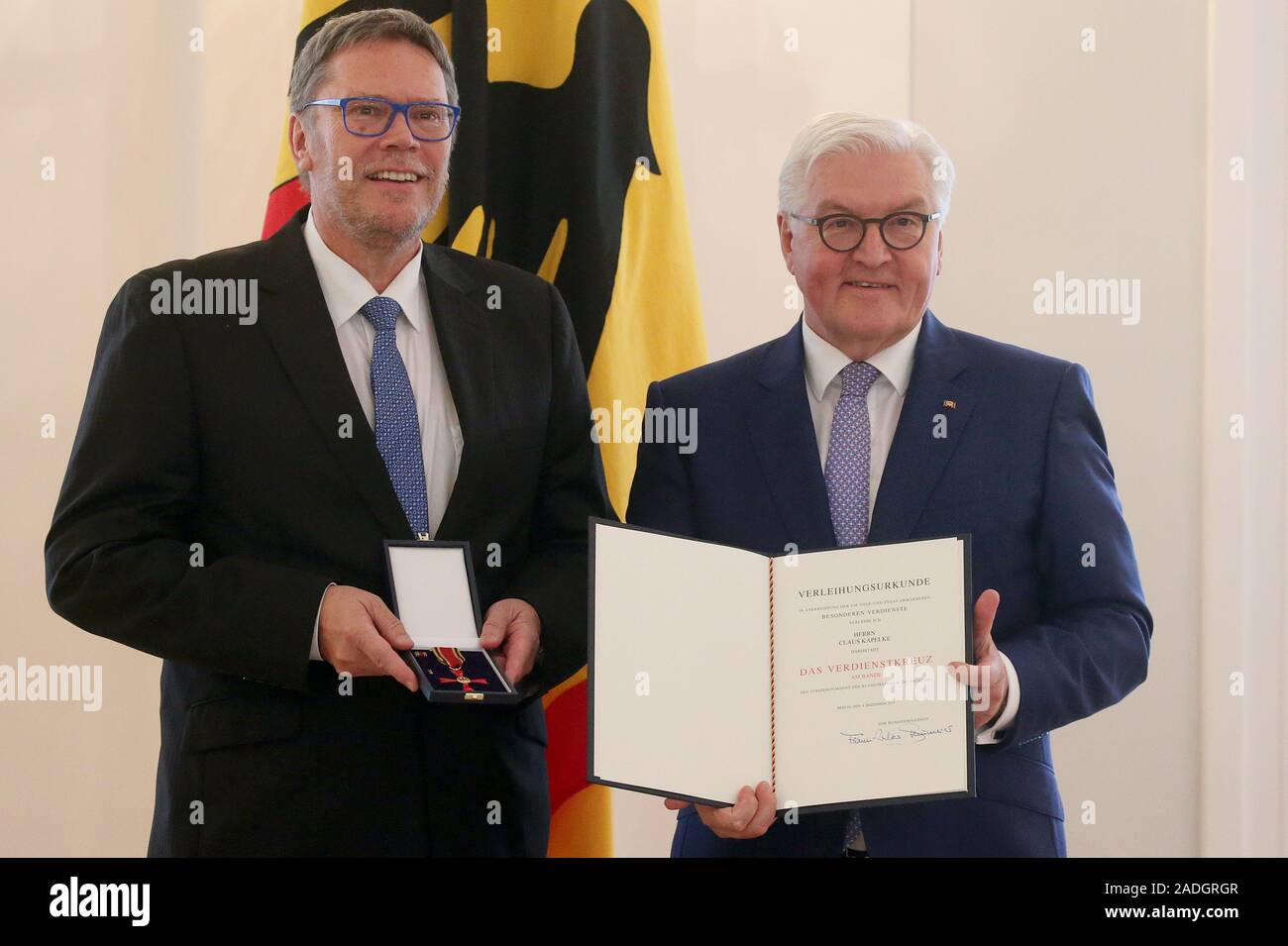 Berlin, Germany. 04th Dec, 2019. Federal President Frank-Walter Steinmeier awards the Order of Merit of the Federal Republic of Germany to Claus Kapelke from Darmstadt in Hesse in Bellevue Palace. Credit: Wolfgang Kumm/dpa/Alamy Live News Stock Photo