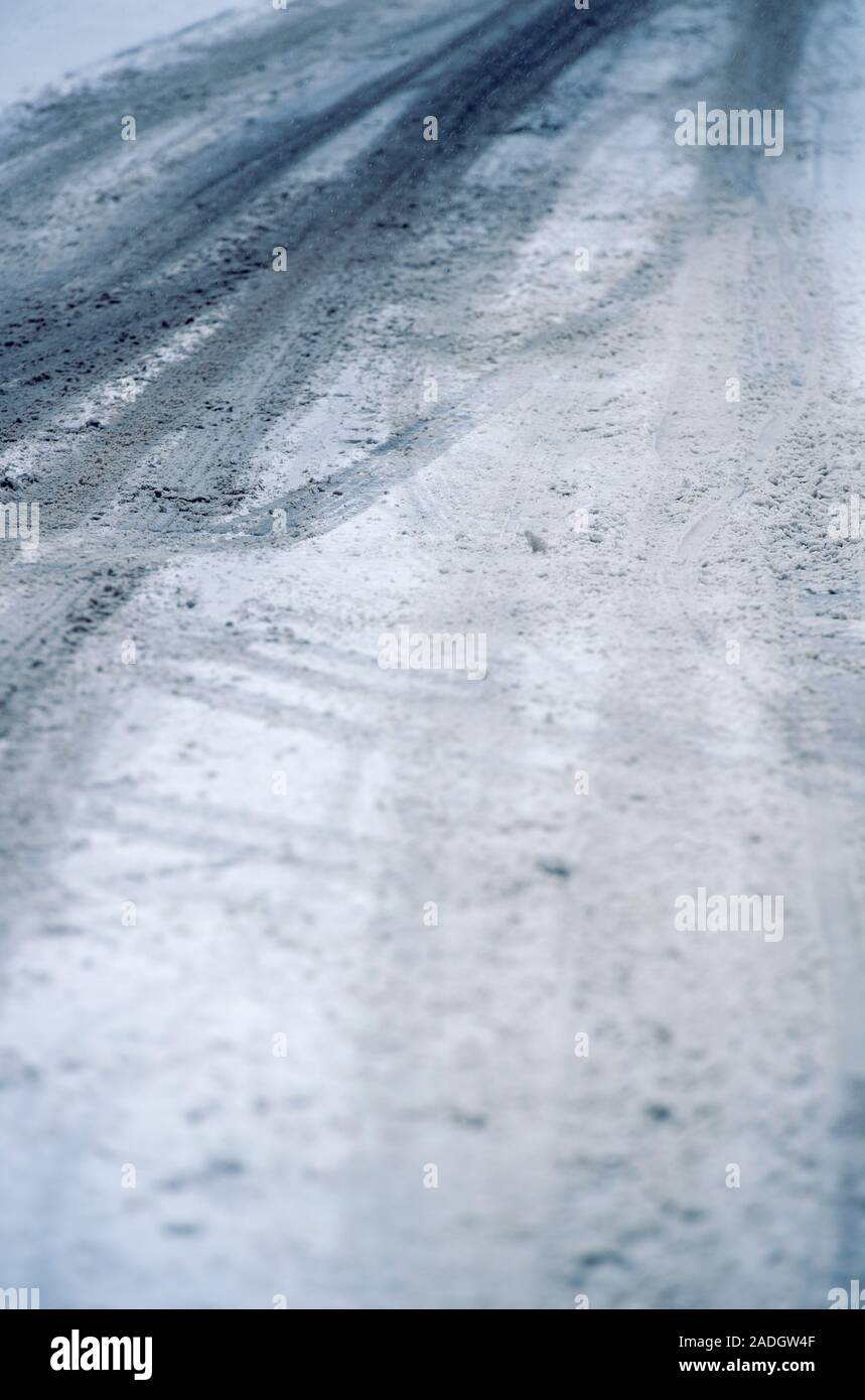 Tyre tracks on an empty road covered in snow and ice Stock Photo - Alamy