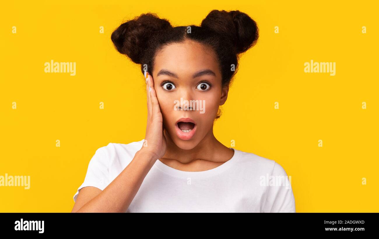 Amazed african american girl looking at camera Stock Photo - Alamy