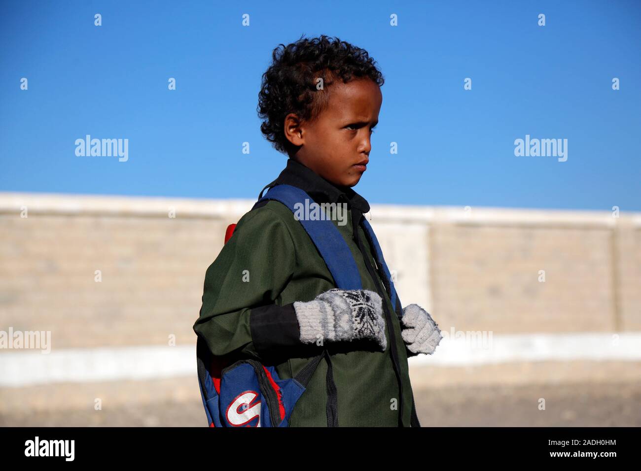 Sanaa, Yemen. 3rd Dec, 2019. A student walks to school in Al-Rahabah area on the northern outskirts of Sanaa, Yemen, on Dec. 3, 2019. During the nearly five years of civil war which has destroyed Yemen's education system, 2 million school-aged children in the country were forced out of school, while 3.7 million others are facing this risk because of the non-payment of teachers' salaries, according to the UNICEF. TO GO WITH 'Feature: Yemeni pupils take classes outside crumbling school building amid bitter winter' Credit: Mohammed Mohammed/Xinhua/Alamy Live News Stock Photo