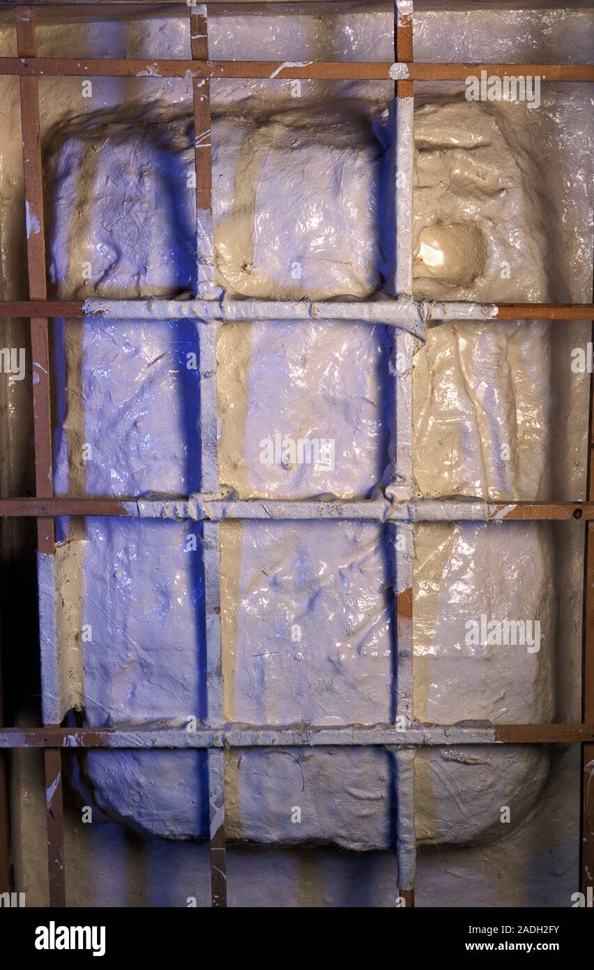 Casting mould. Metal grid frame over a casting mould. The mould is