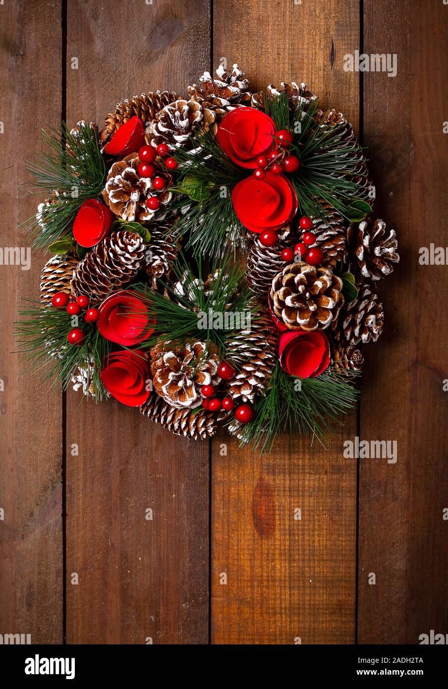 beautiful Christmas wreath of cones of paper flowers and fir branches ...