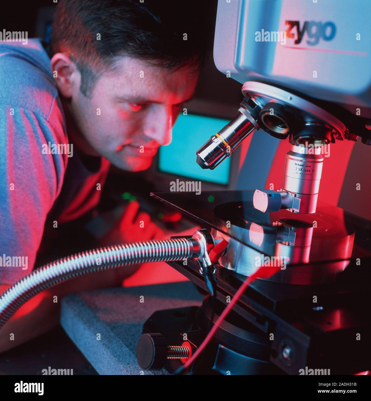 Interference microscope. Technician using an interference microscope ...
