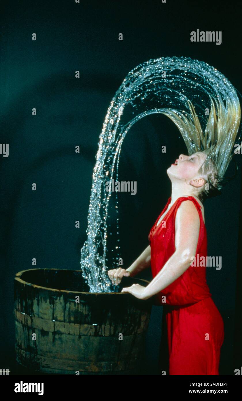 High speed photograph of the arc of water formed when a woman wets her