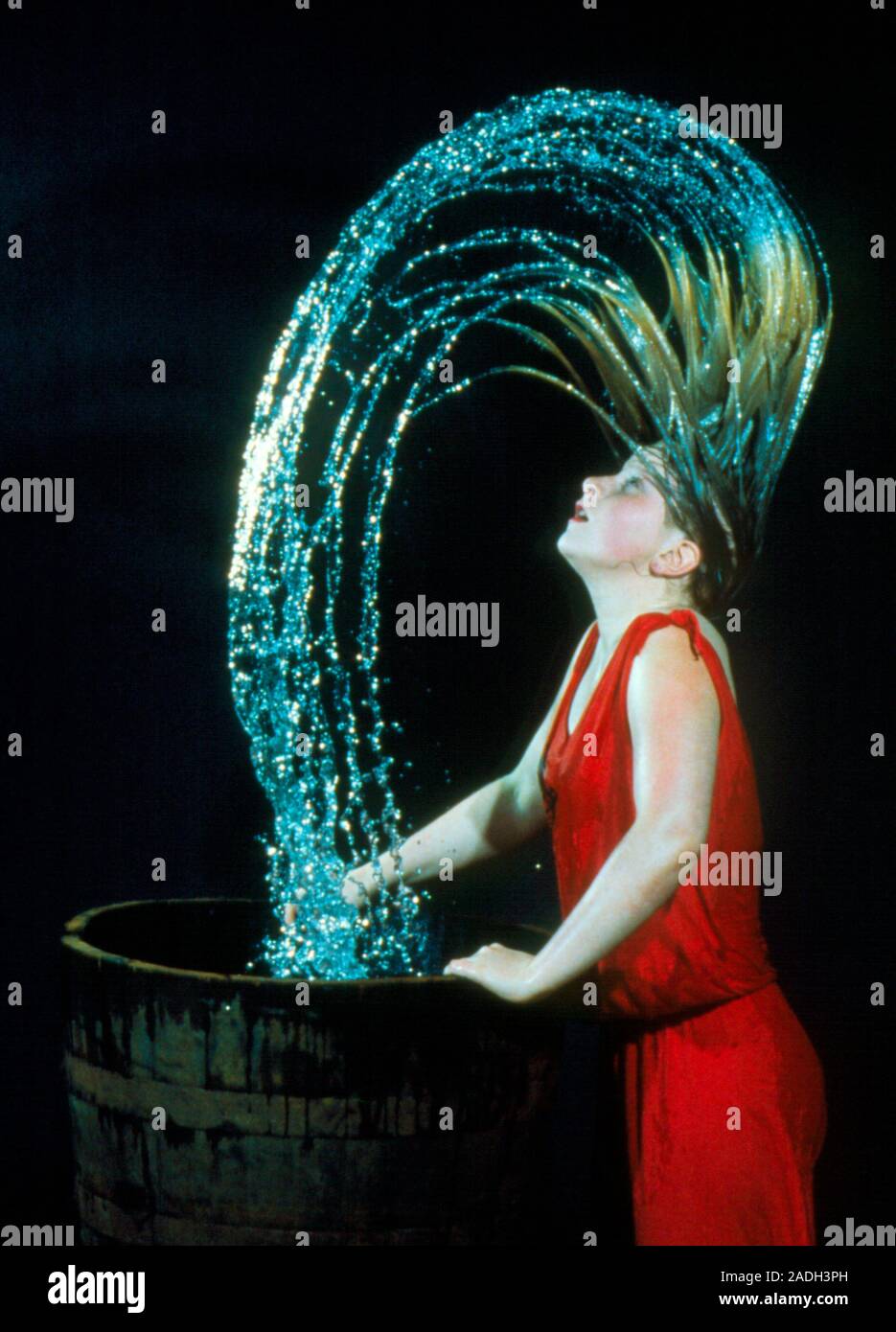 High speed photograph of the arc of water formed when a woman wets her