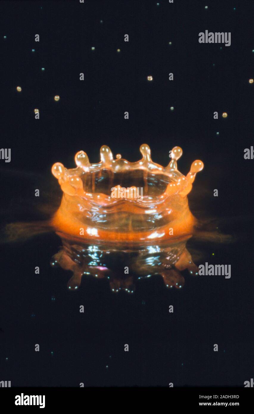 Highspeed photograph of a drop of liquid landing on water and