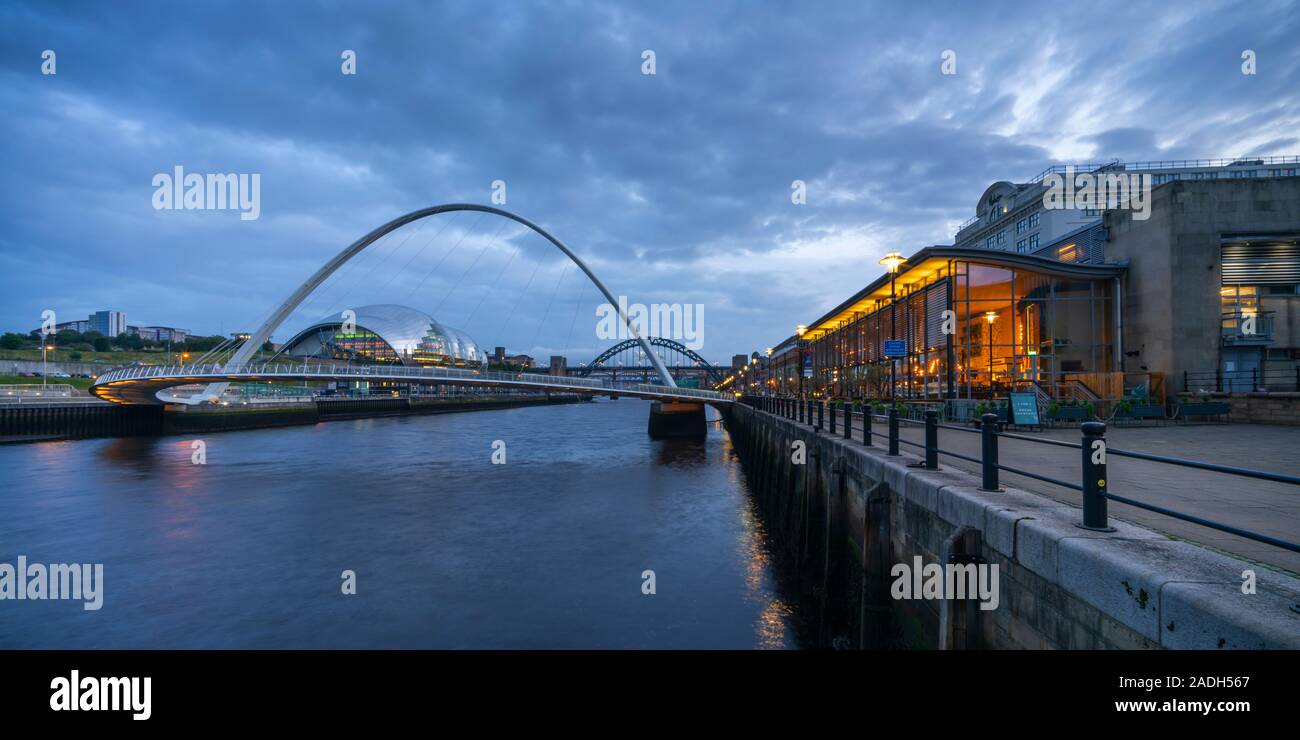 Newcastle and Gateshead quaysides at dusk, including the arch of the Millennium Bridge, the Sage and the Tyne Bridge, Tyne and Wear, England Stock Photo