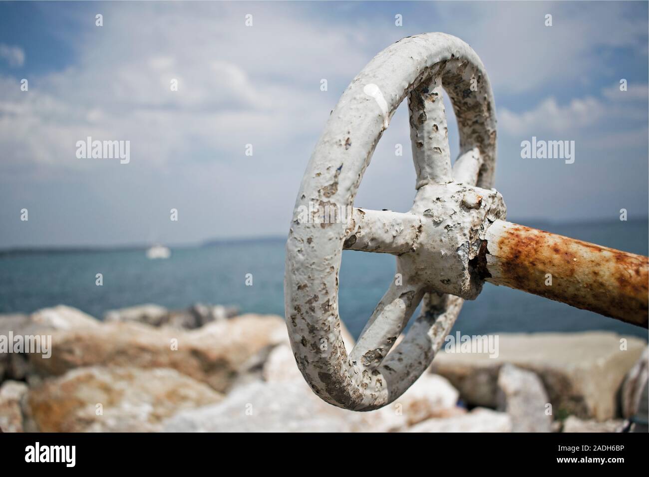 Rusted iron valve and sea, Urla, Izmir Stock Photo