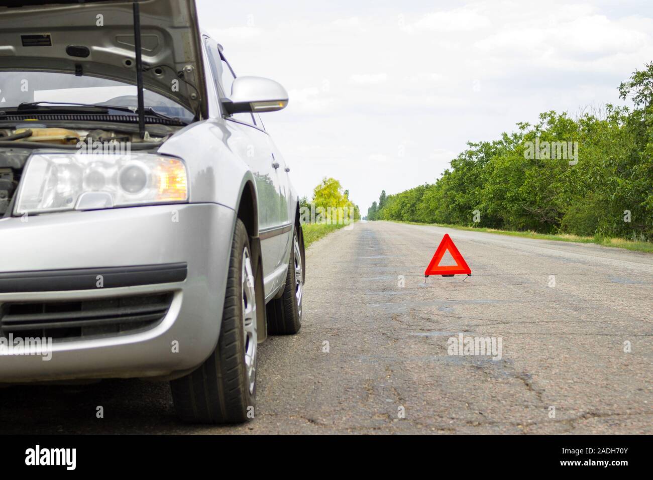 Red triangle of a car on the road. Car warning triangle on the road