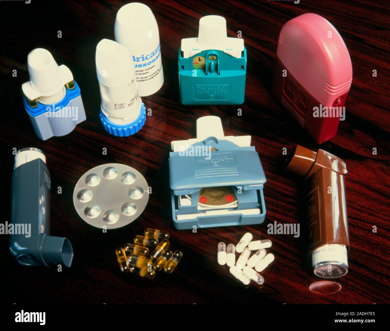 Assorted asthma inhalers. At top left are spinhalers or turbohalers