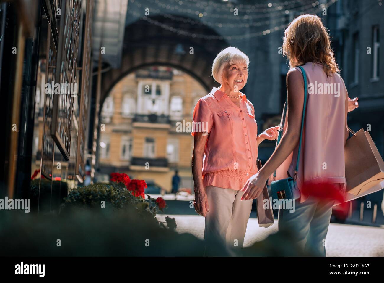 Cheerful woman talking to daughter and smiling stock photo Stock Photo