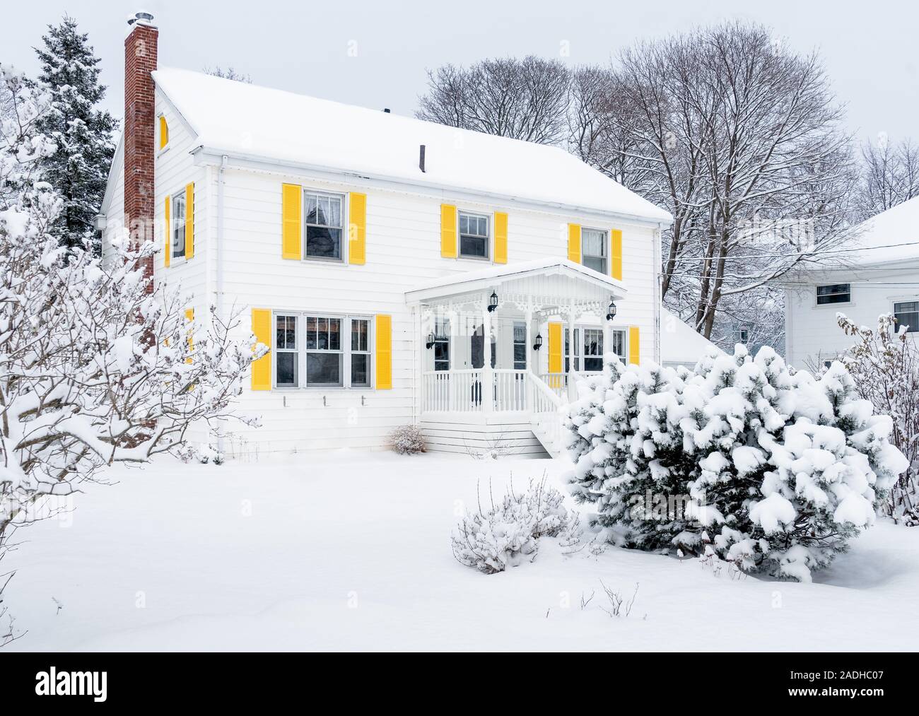 Traditional older family home covered in snow. Stock Photo