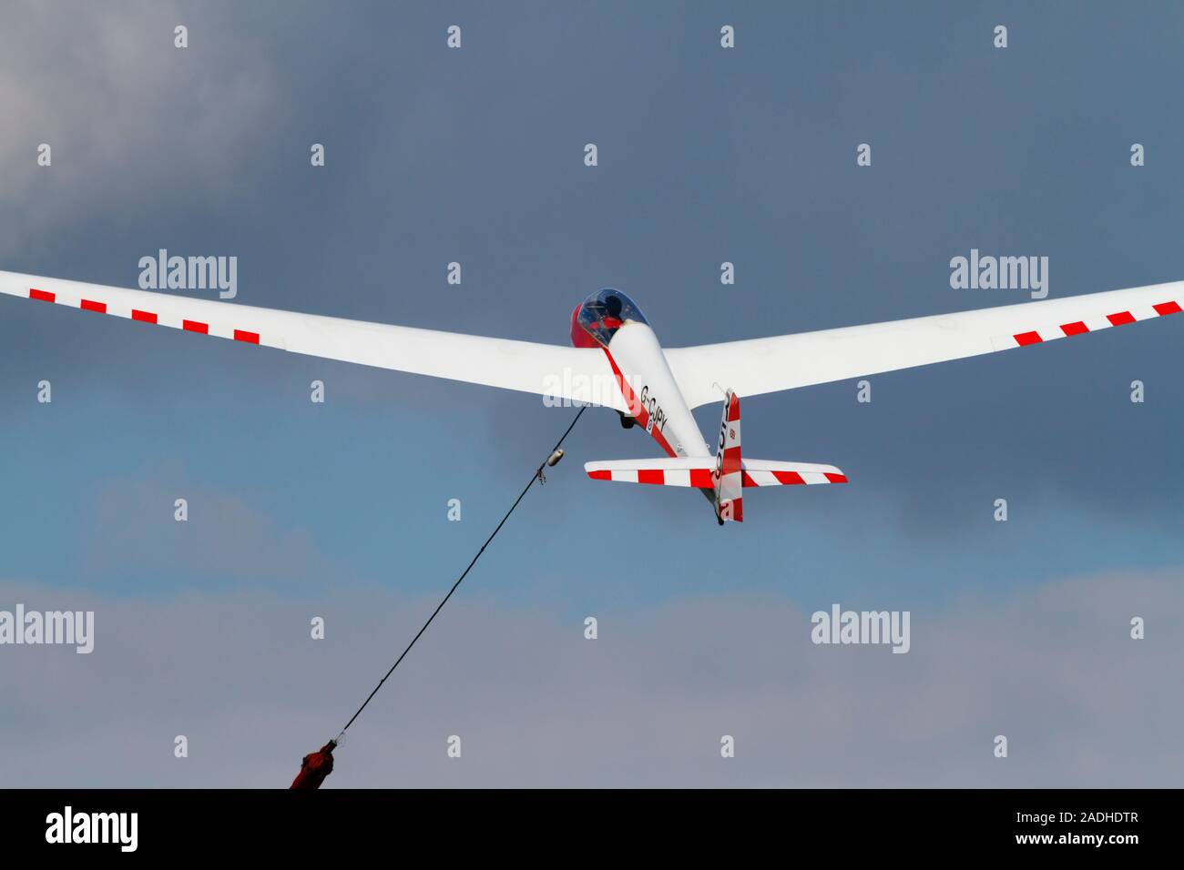 Schleicher ASK13 glider of the RAFGSA takes a winch launch from Cranwell airfield. Stock Photo