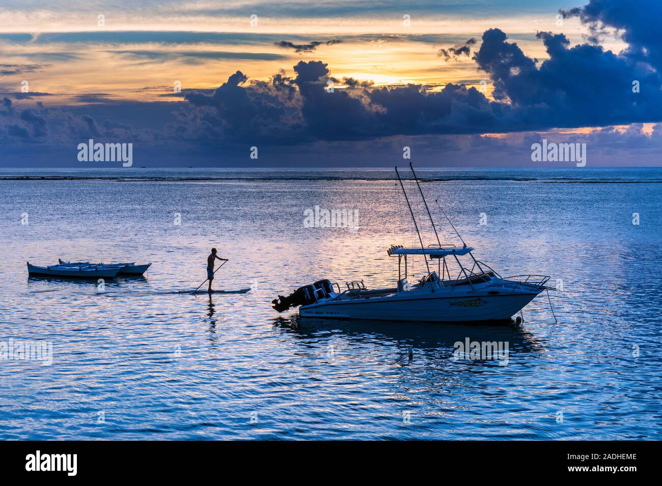 Stand-up paddle boarder off Riviere Noir or Black River beach, Tamarin, Mauritius, Mascarene Islands. Stock Photo
