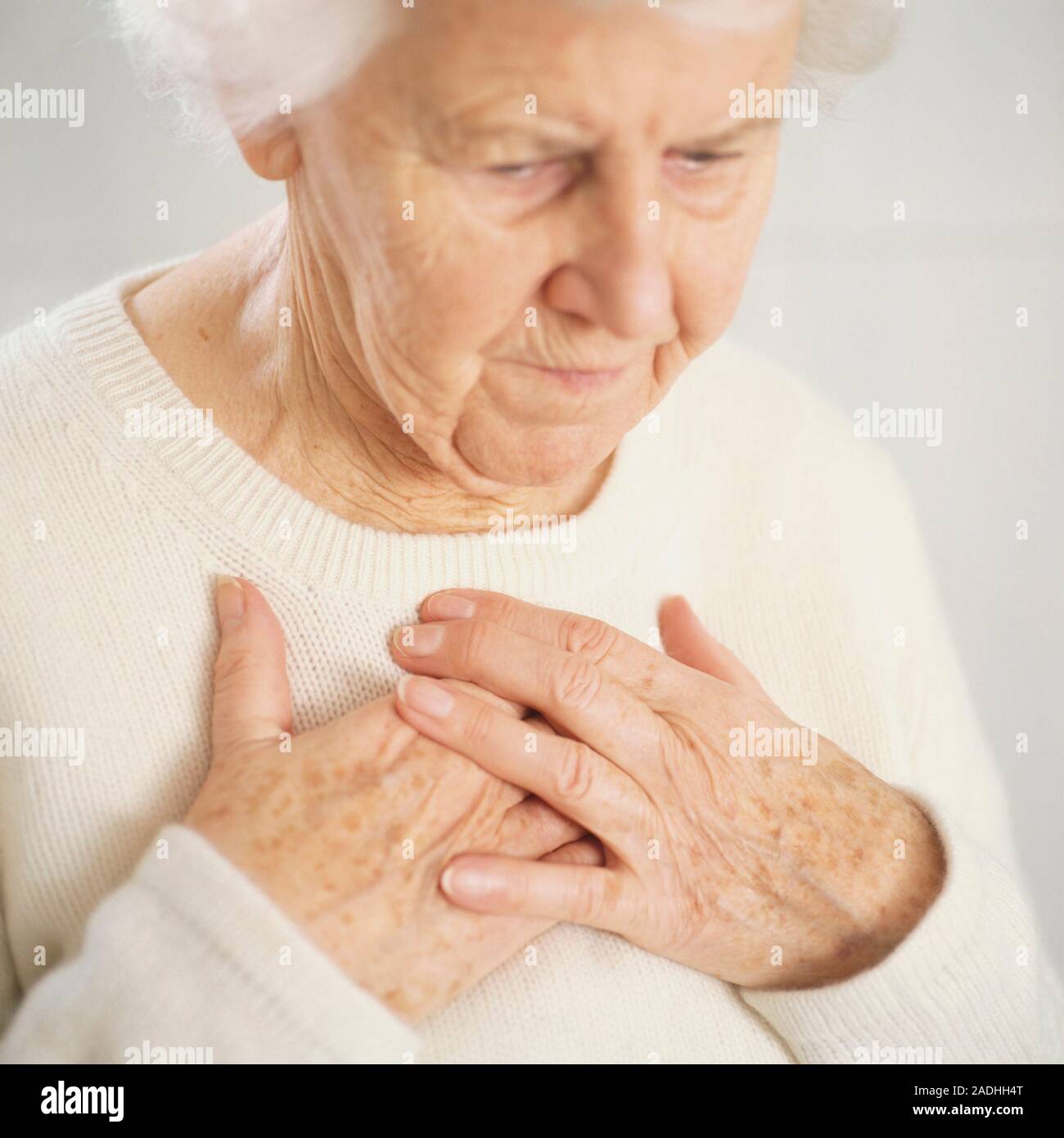 Chest pain. Elderly woman clutching her painful chest Stock Photo Alamy