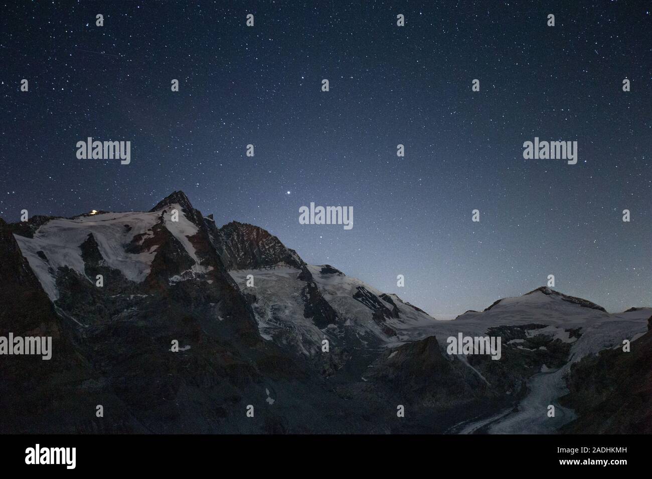Starry sky, night landscape. The Glocknergruppe alpine massif; Großglockner mountain peak. Hohe Tauern National Park. Austrian Alps. Europe. Stock Photo