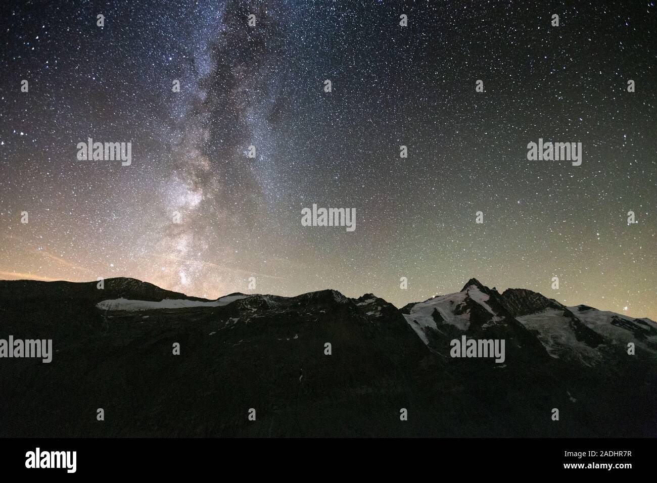 Starry sky, Milky Way. Night landscape. The Glocknergruppe alpine massif; Großglockner mountain peak. Hohe Tauern National Park. Austrian Alps. Europe Stock Photo
