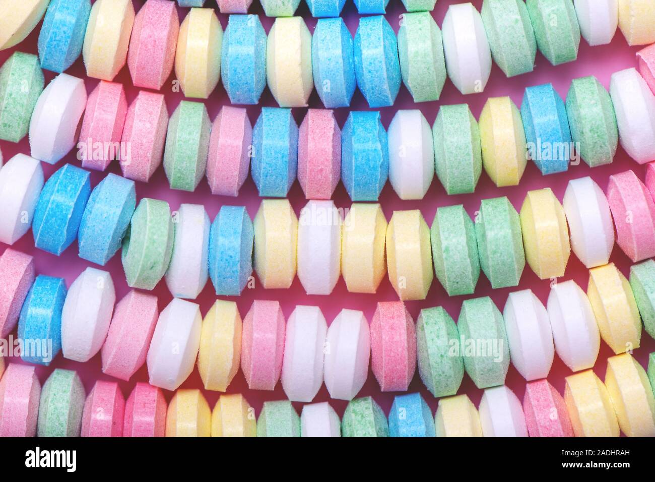 Pastel background made of multicolored candy necklace. Stock Photo