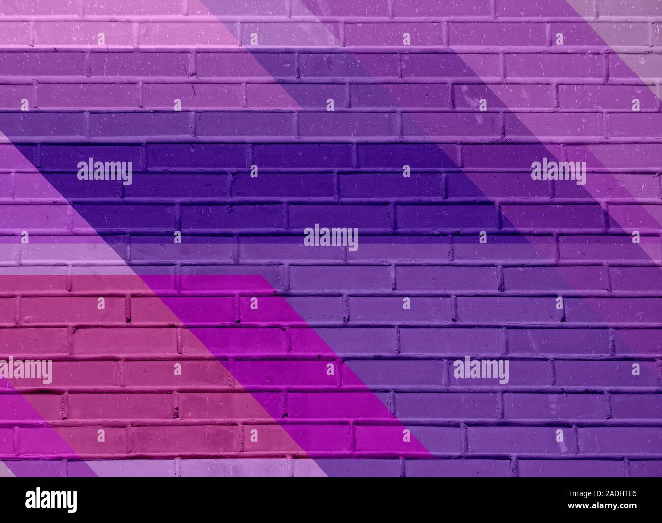 Brick wall texture with paint painted stylish street art design. Abstract multicolor urban graffiti. Stock Photo
