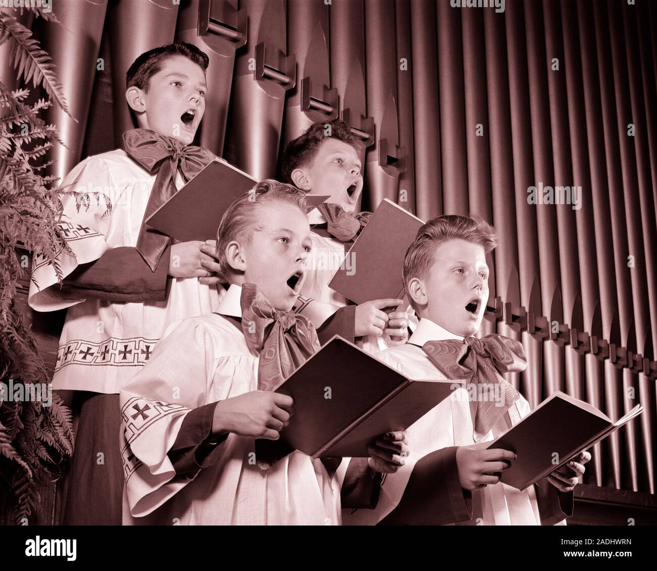 1940s FOUR CHOIRBOYS SINGING TOGETHER HOLDING HYMN BOOKS STANDING IN FRONT OF CHURCH ORGAN PIPES - c2873 HAR001 HARS INSPIRATION CARING MALES ENTERTAINMENT SIBLINGS SPIRITUALITY CONFIDENCE CHORUS B&W SUCCESS PERFORMING ARTS PIPES STRENGTH LOW ANGLE POWERFUL RECREATION HYMN PRIDE SIBLING CONCEPTUAL STYLISH IN FRONT OF CHORAL CHOIRBOYS COOPERATION GROWTH HARMONY HONORABLE JUVENILES PRE-TEEN PRE-TEEN BOY PRECISION TOGETHERNESS VOICES BLACK AND WHITE CAUCASIAN ETHNICITY HAR001 OLD FASHIONED Stock Photo