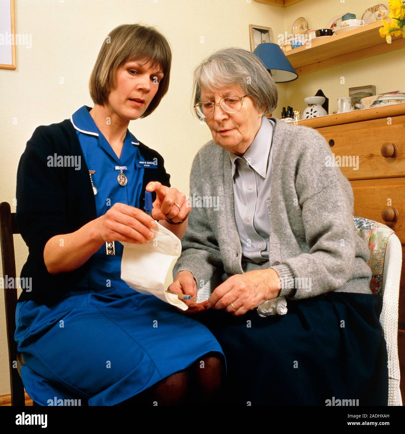 Incontinence bag. A district nurse explains the use of a urinary